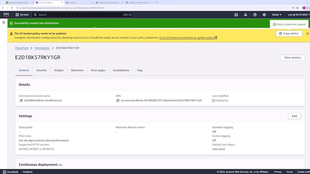 The image shows an AWS CloudFront distribution management page, indicating a new distribution has been successfully created, with a notification to update the S3 bucket policy.