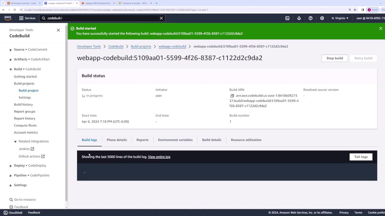The image shows an AWS CodeBuild interface with a build in progress for a project named "webapp-codebuild." The build status, start time, and other details are displayed on the screen.