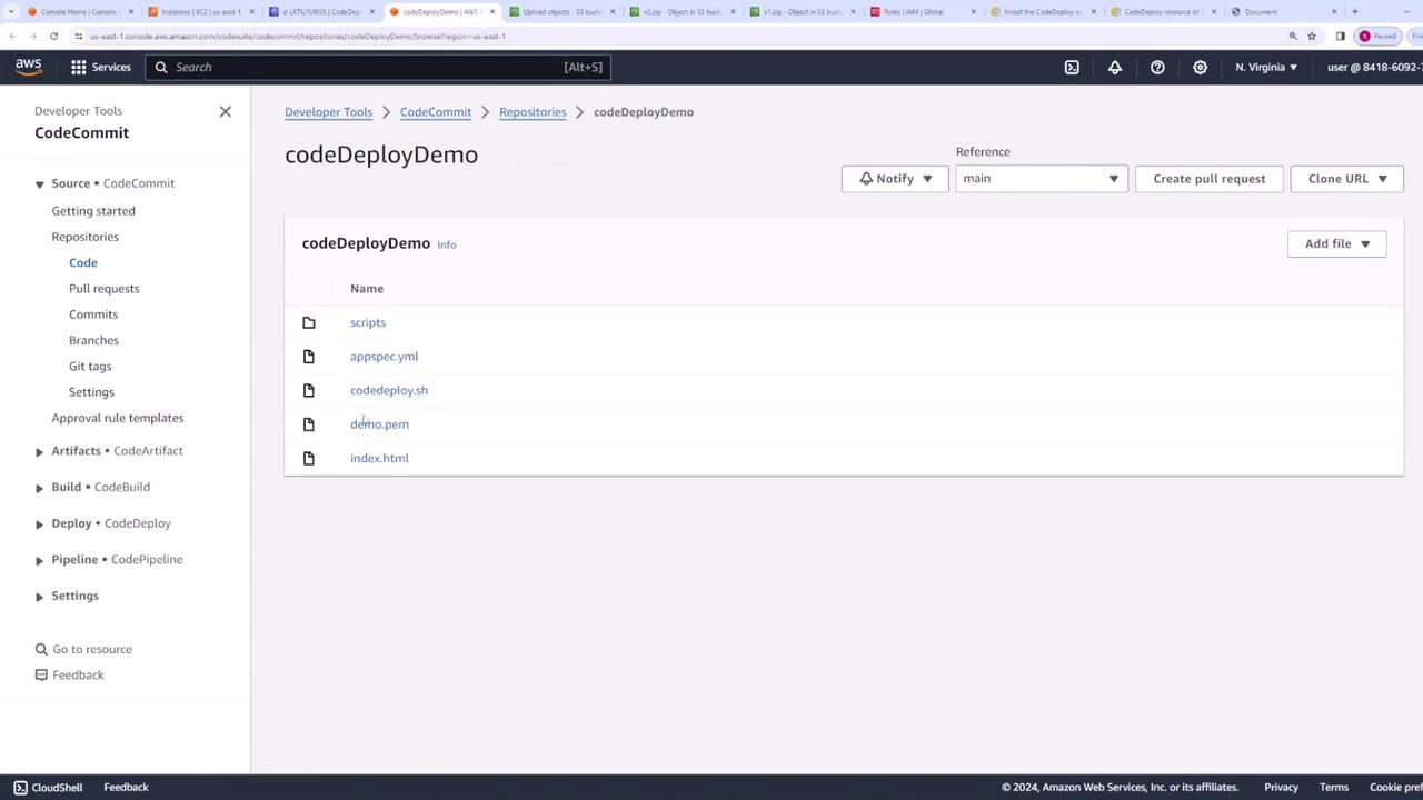 The image shows an AWS CodeCommit repository named "codeDeployDemo" with a list of files including scripts, appspec.yml, codedeploy.sh, demo.pem, and index.html. The interface displays options for managing the repository, such as creating a pull request and cloning the URL.