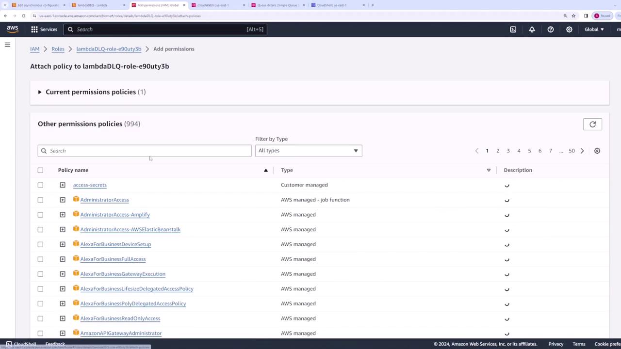 The image shows an AWS IAM console screen where a user is attaching a policy to a role named "lambdaDLQ-role-e90uty3b." It lists various permission policies available for selection.