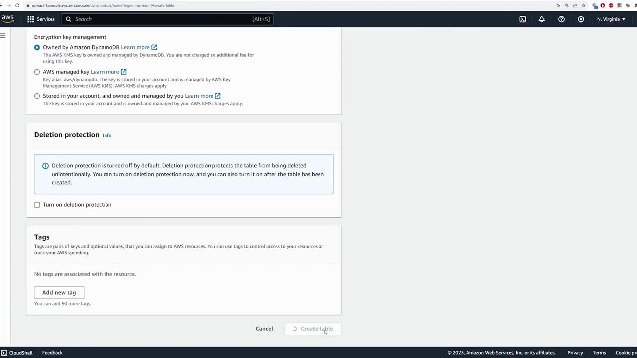 The image shows a section of the AWS DynamoDB console, focusing on encryption key management, deletion protection, and tagging options for creating a table.