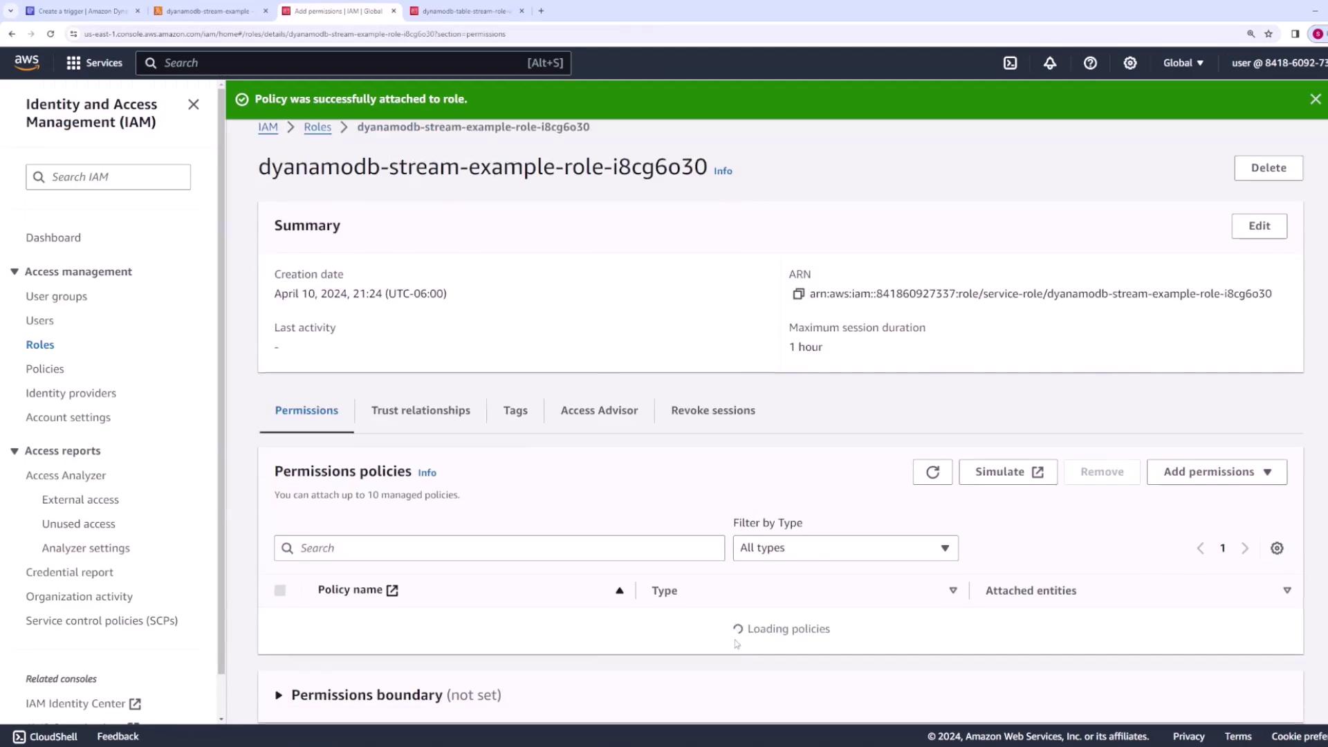 The image shows an AWS Identity and Access Management (IAM) console screen, displaying details of a role named "dynamodb-stream-example-role-i8cg6o30," including its creation date and permissions policies.
