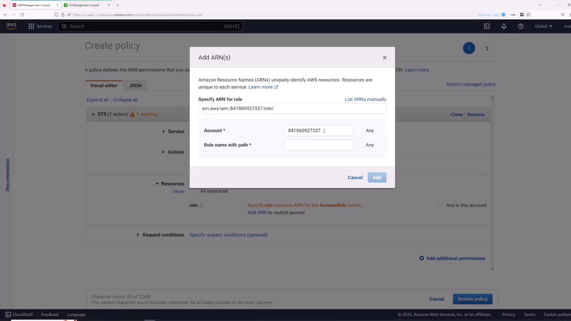 The image shows an AWS IAM Management Console screen where a user is adding an Amazon Resource Name (ARN) for a role in a policy. The dialog box includes fields for specifying the account number and role name.