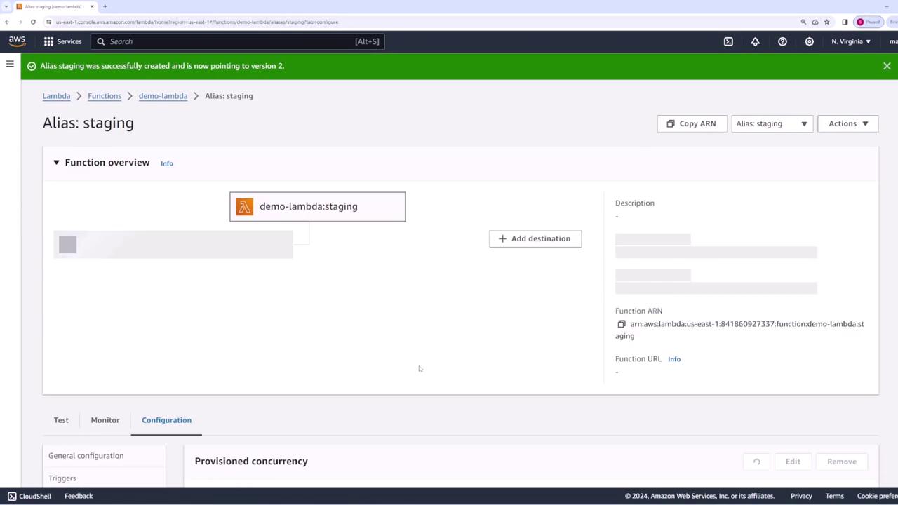 The image shows an AWS Lambda console with an alias named "staging" pointing to a function called "demo-lambda." A green notification bar indicates the alias was successfully created and is pointing to version 2.