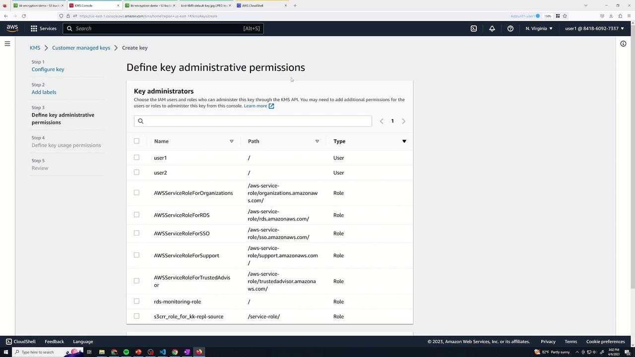 The image shows an AWS KMS console screen where key administrative permissions are being defined, listing various users and roles with their paths and types.