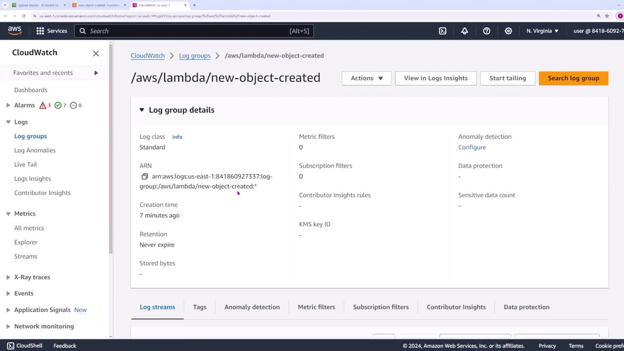 The image shows an AWS CloudWatch interface displaying log group details for "/aws/lambda/new-object-created," including information like ARN, creation time, and metric filters.