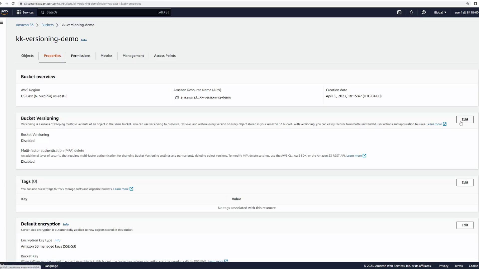 The image shows the properties page of an Amazon S3 bucket named "kk-versioning-demo" in the AWS Management Console. It displays details about bucket versioning, tags, and default encryption settings, with options to edit these configurations.