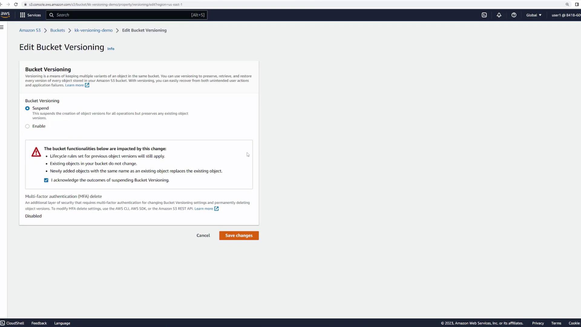 The image shows the "Edit Bucket Versioning" page in the Amazon S3 console, where users can enable or suspend versioning for a bucket. It includes options for multi-factor authentication and a warning about the impact of suspending versioning.
