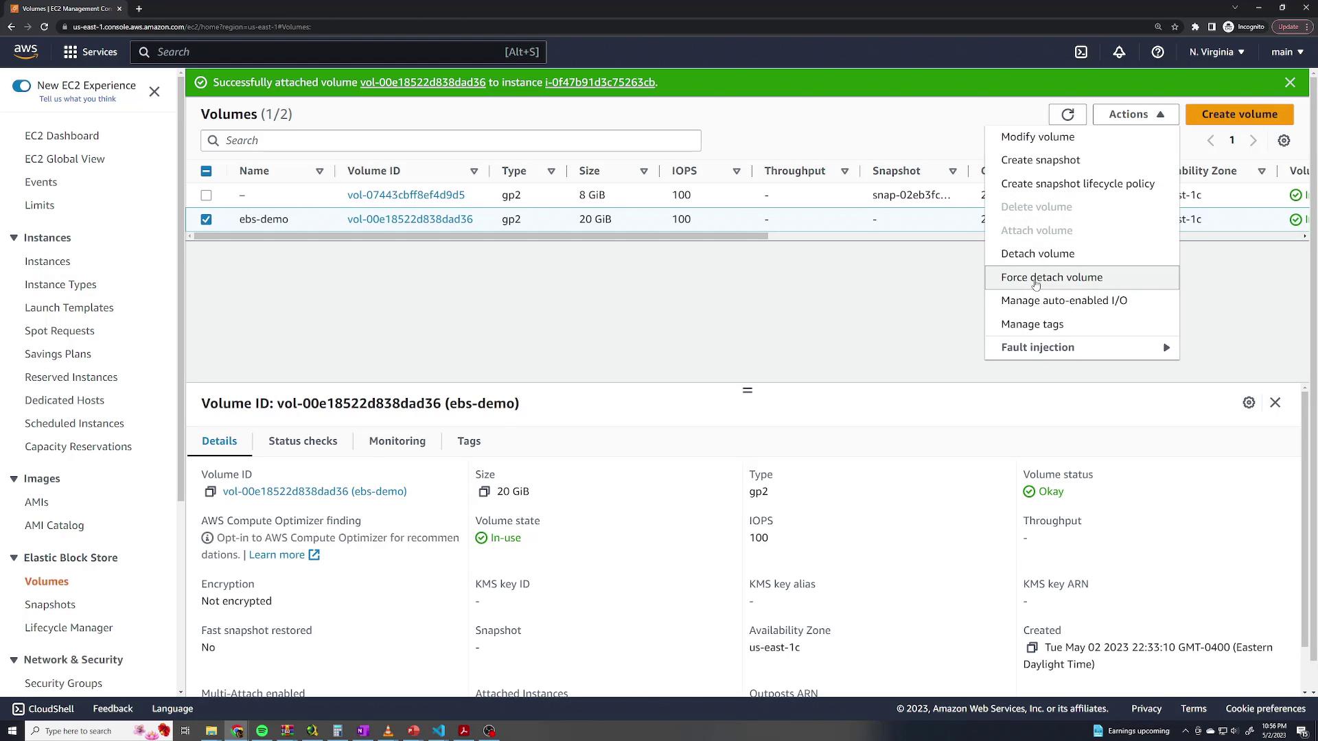 The image shows an AWS EC2 management console with details of two EBS volumes, including their IDs, types, sizes, and status, with a menu for volume actions.