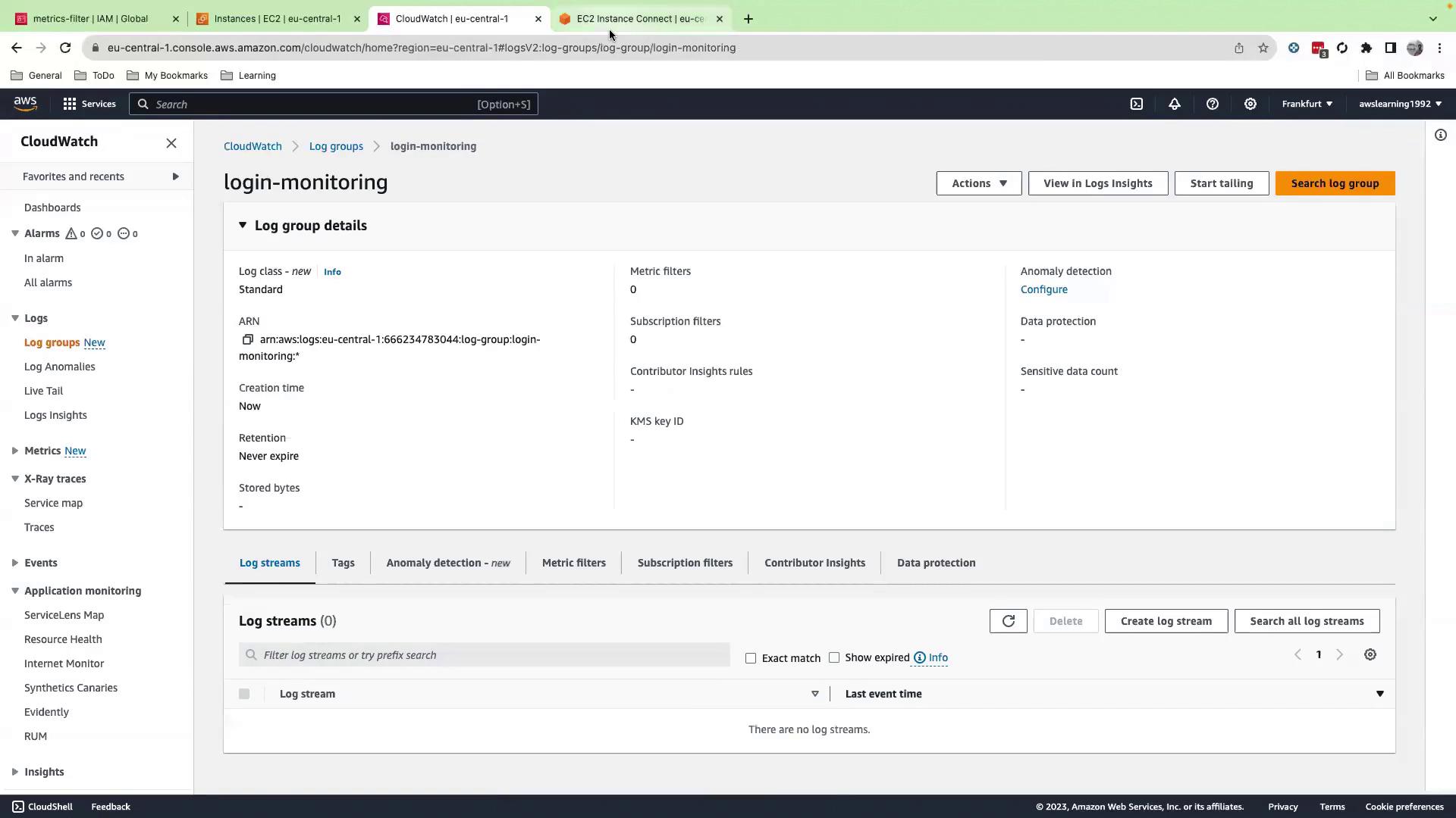 The image shows an AWS CloudWatch interface displaying details of a log group named "login-monitoring," including its ARN, creation time, and retention settings. The interface also shows options for configuring anomaly detection and managing log streams.