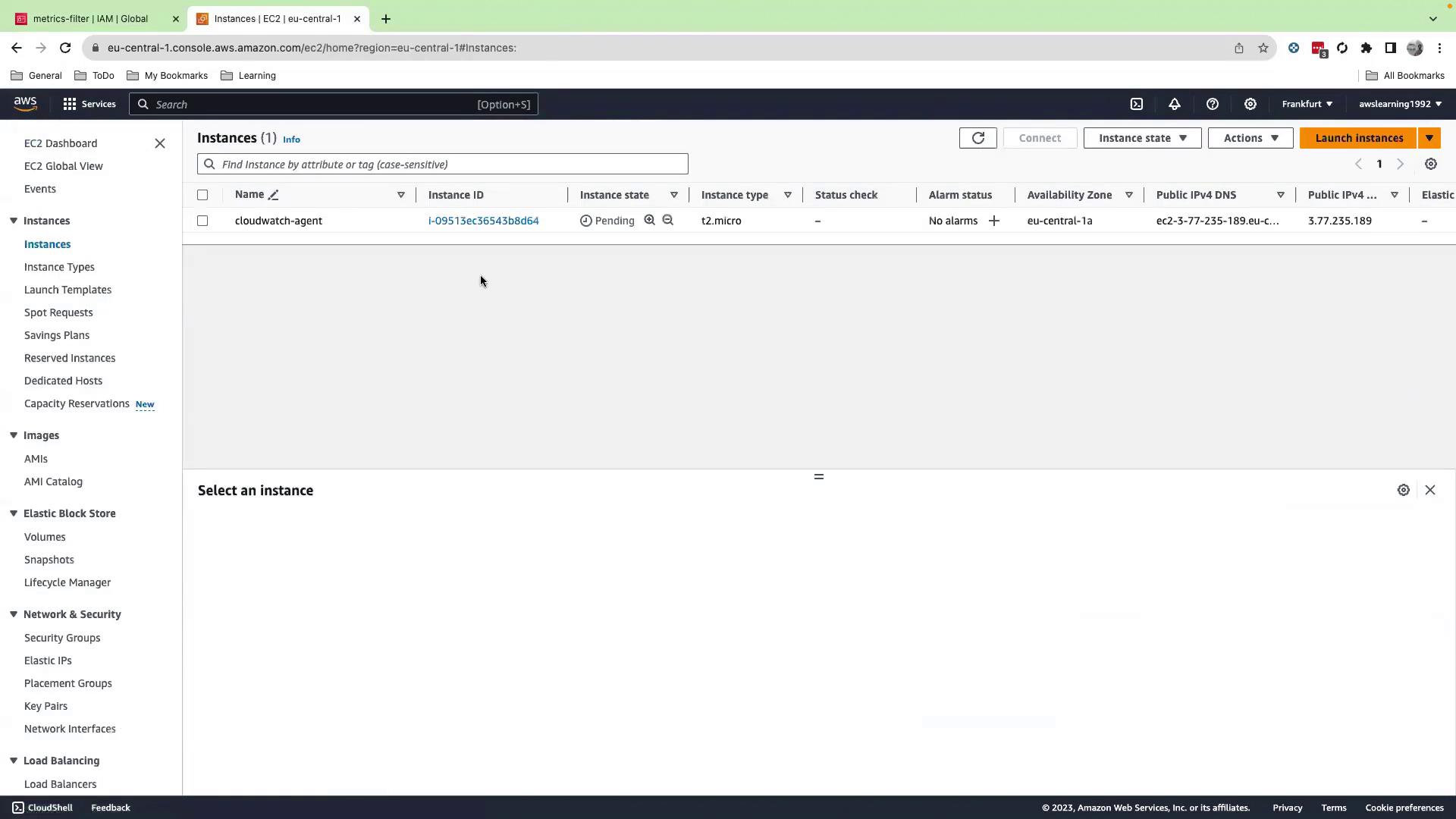 The image shows an AWS EC2 management console with one instance listed, named "cloudwatch-agent," which is in a pending state. The console displays various details such as instance ID, type, and status checks.