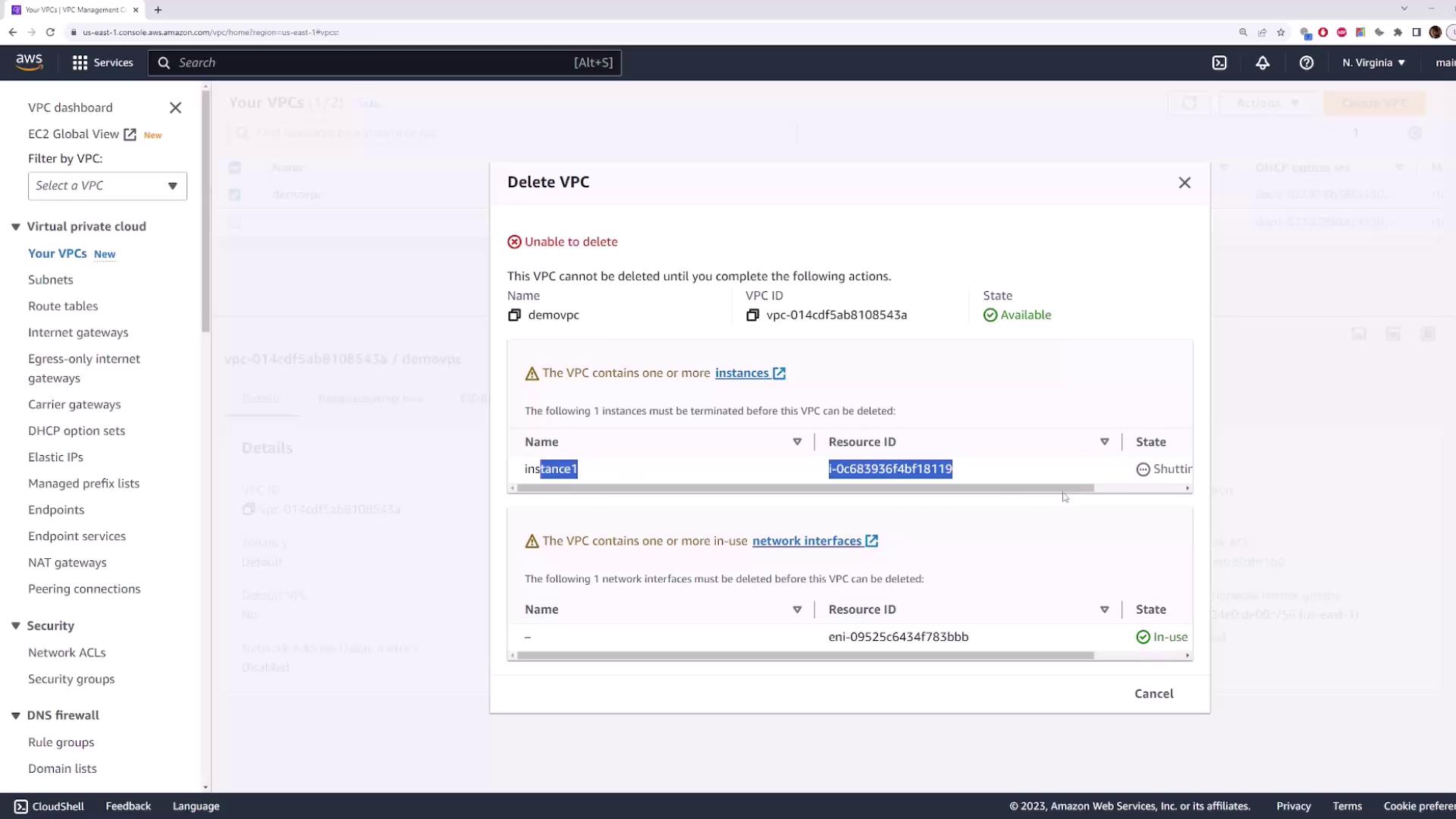 The image shows an AWS VPC management console with a "Delete VPC" dialog open, indicating that the VPC cannot be deleted due to existing instances and network interfaces.