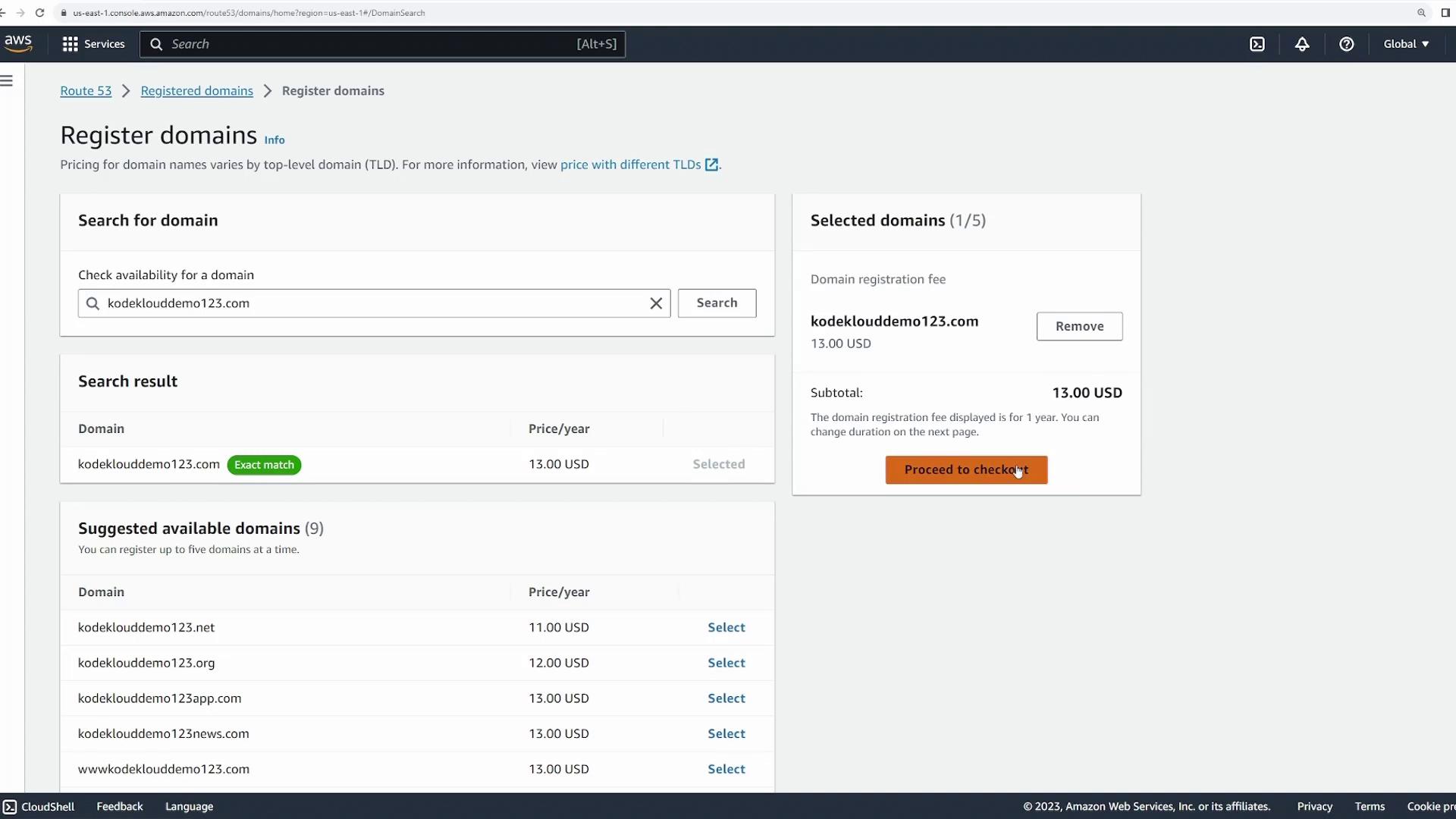 The image shows an AWS Route 53 domain registration page where the domain "kodeklouddemo123.com" is selected for purchase at $13.00 USD per year, with an option to proceed to checkout.