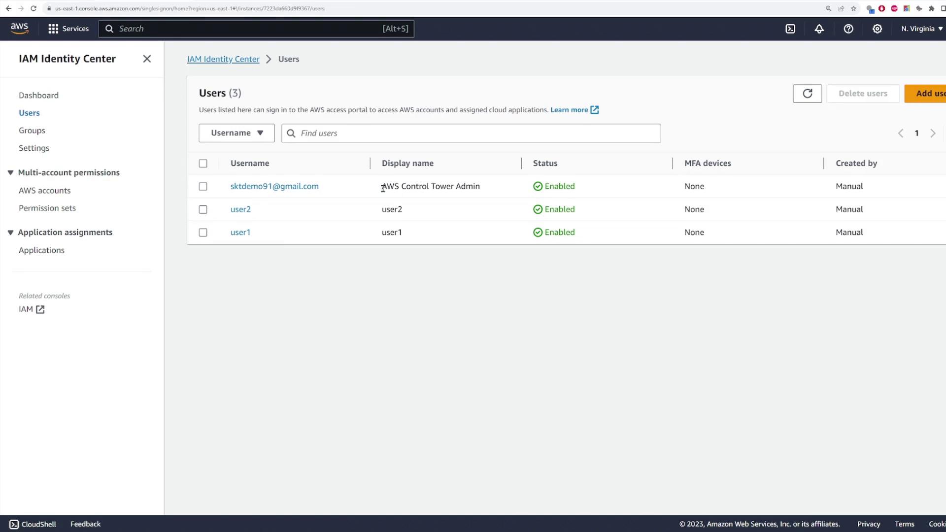 The image shows the AWS IAM Identity Center interface displaying a list of users, their display names, statuses, MFA devices, and creation methods.