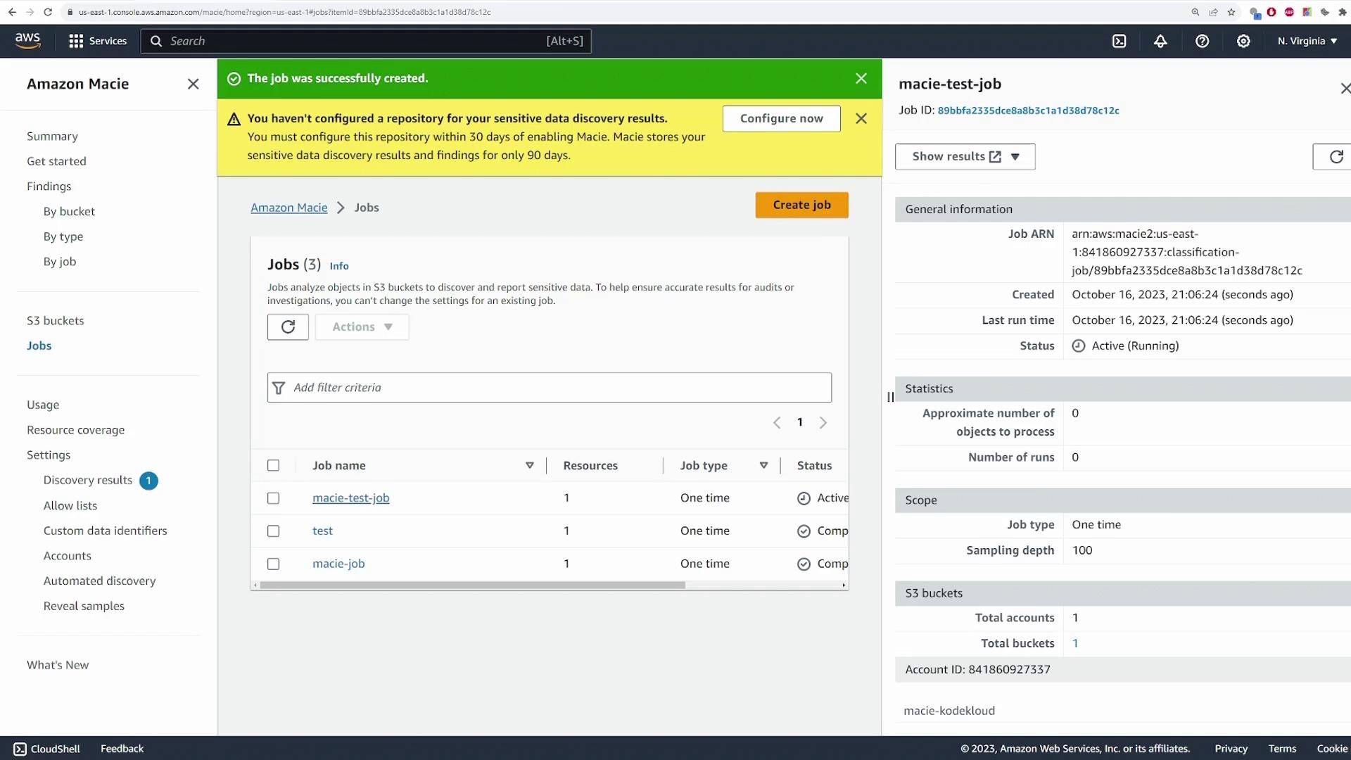 The image shows the Amazon Macie console with a list of jobs for analyzing sensitive data in S3 buckets. A notification indicates that a job was successfully created, but a repository for sensitive data discovery results needs configuration.