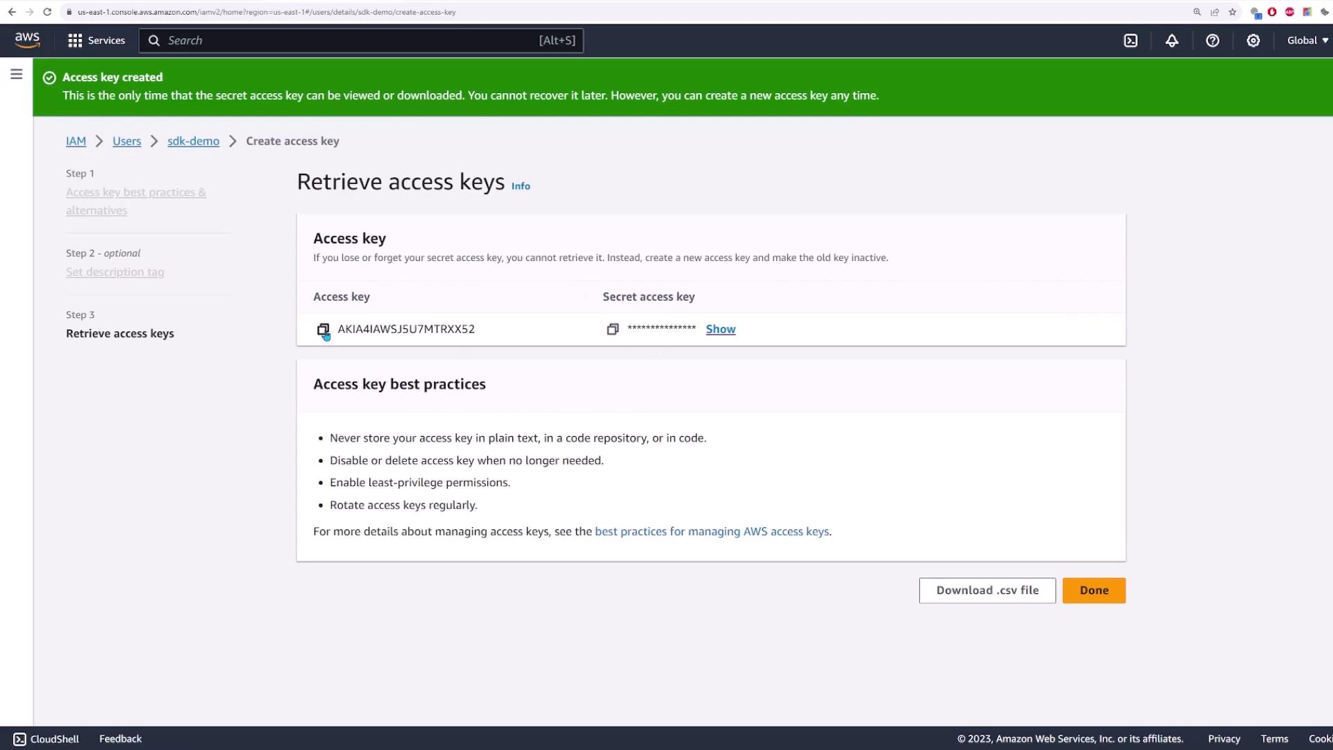 The image shows an AWS IAM console screen displaying access key details and best practices for managing access keys. A green banner at the top indicates that an access key has been created.