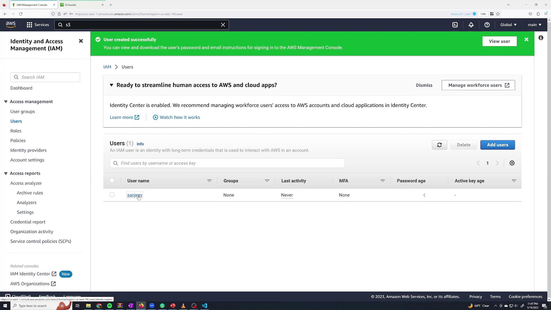 The image shows the AWS Identity and Access Management (IAM) console, displaying a user management interface with a notification about a user being created successfully. A user named "sanjeev" is listed with details such as groups, last activity, and MFA status.