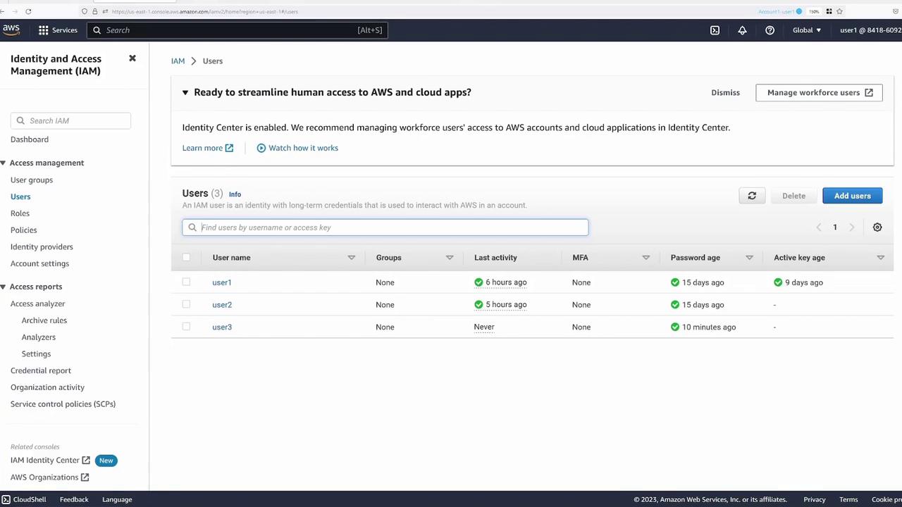 The image shows an AWS Identity and Access Management (IAM) dashboard displaying a list of users with details such as last activity, MFA status, password age, and active key age.