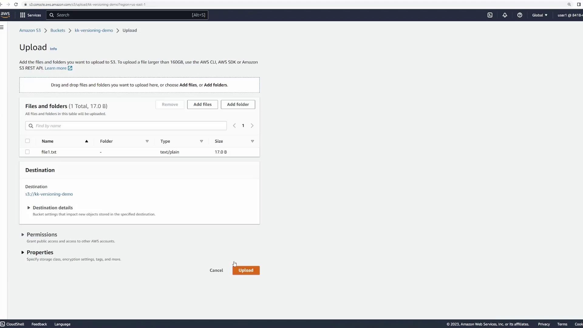 The image shows an Amazon S3 upload interface where a file named "file1.txt" is being prepared for upload to a bucket named "kk-versioning-demo." The file is 17 bytes in size and the "Upload" button is visible.