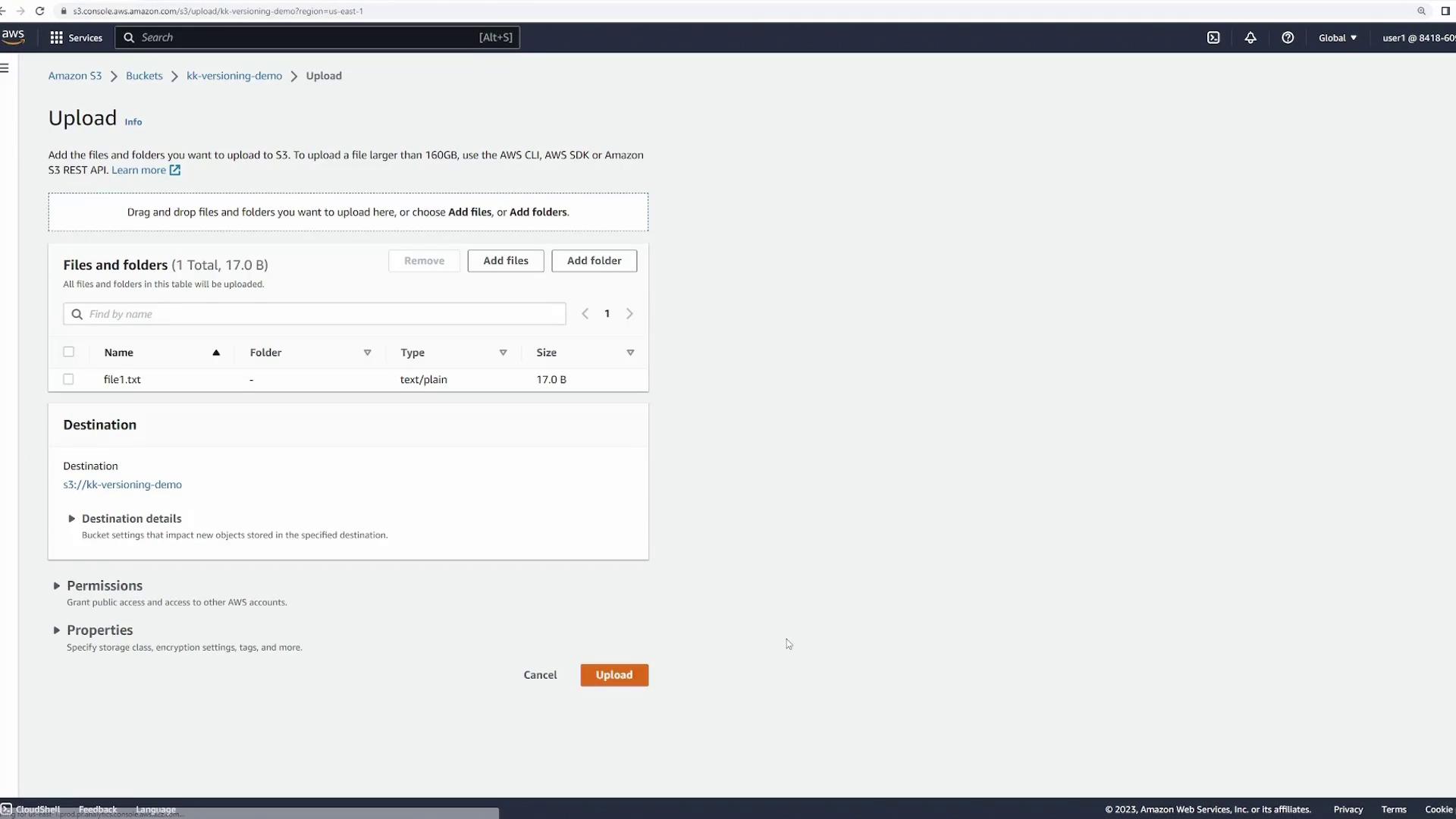 The image shows an Amazon S3 upload interface with a file named "file1.txt" ready to be uploaded to a bucket named "kk-versioning-demo." The file is 17.0 bytes in size and is of type "text/plain."