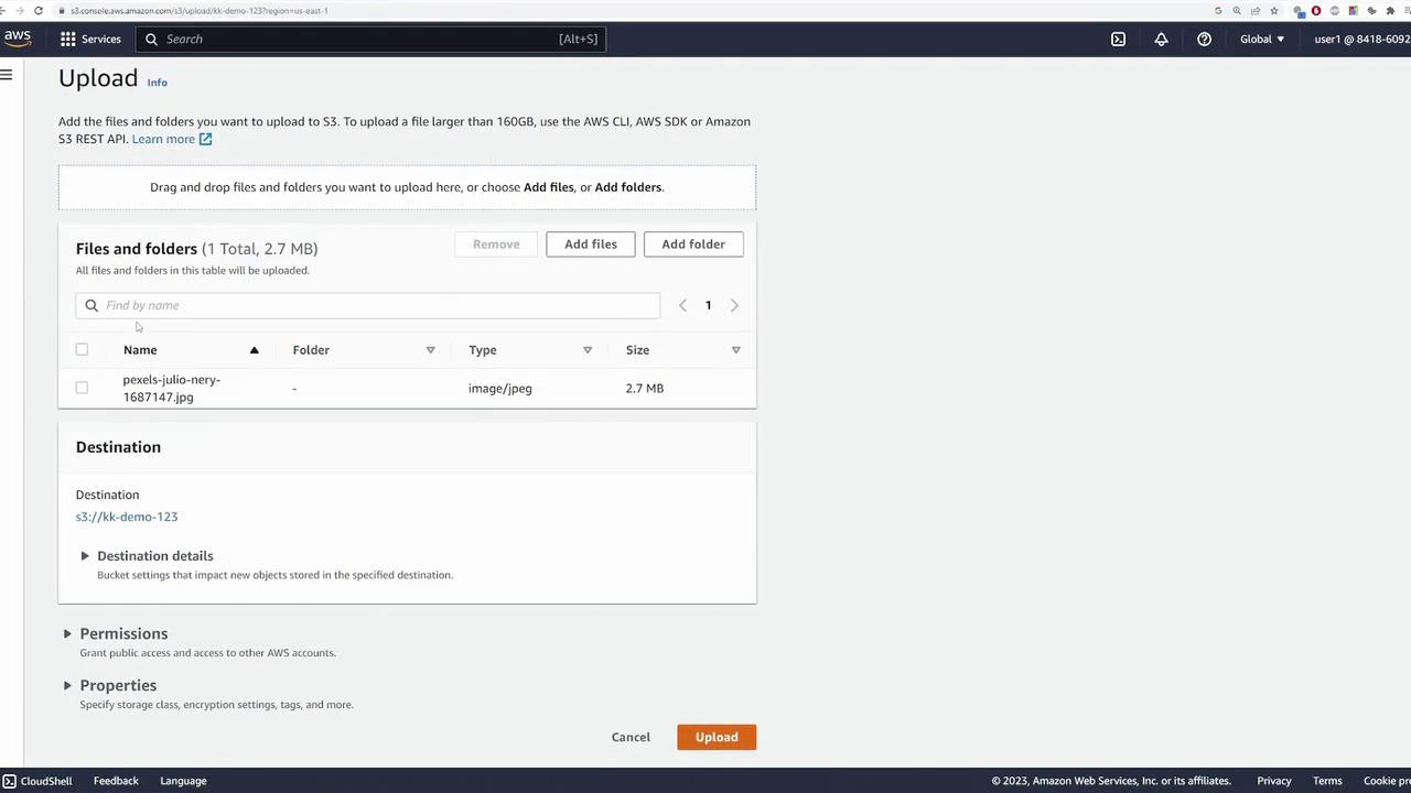 The image shows an AWS S3 upload interface with a file named "pexels-julio-nery-1687147.jpg" ready to be uploaded. The file is 2.7 MB in size, and the destination bucket is "kk-demo-123".