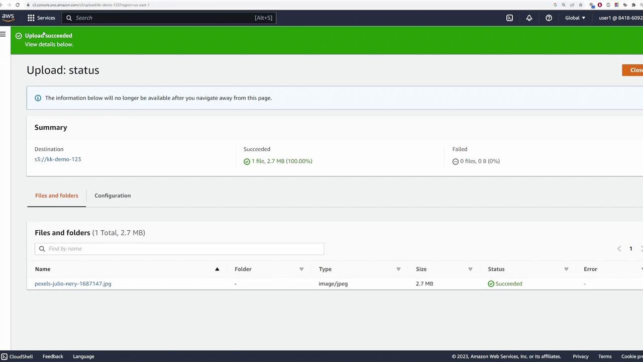 The image shows an AWS S3 upload status page indicating a successful upload of a file named "pexels-julio-nery-1687147.jpg" with a size of 2.7 MB. The upload summary shows 1 file succeeded and 0 files failed.