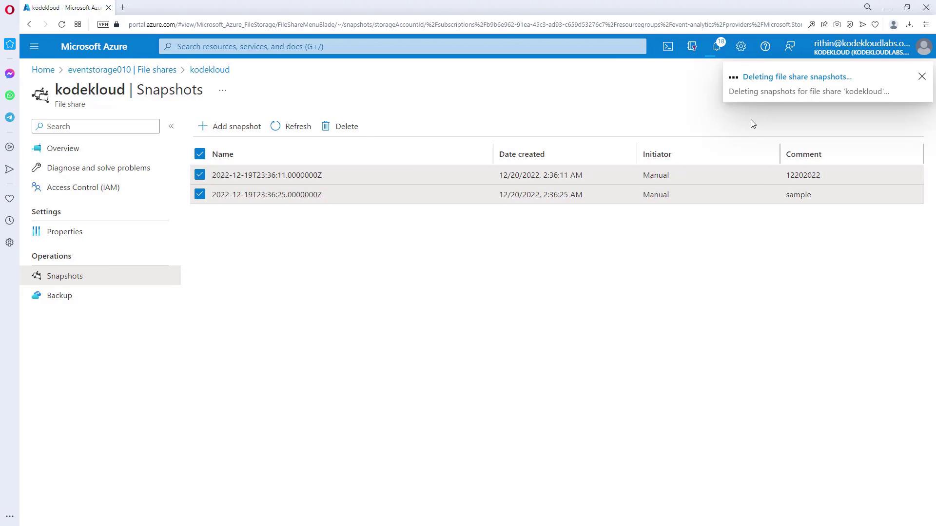 The image shows a Microsoft Azure portal interface displaying a list of file share snapshots for "kodekloud," with options to add, refresh, or delete snapshots. A notification indicates that file share snapshots are being deleted.