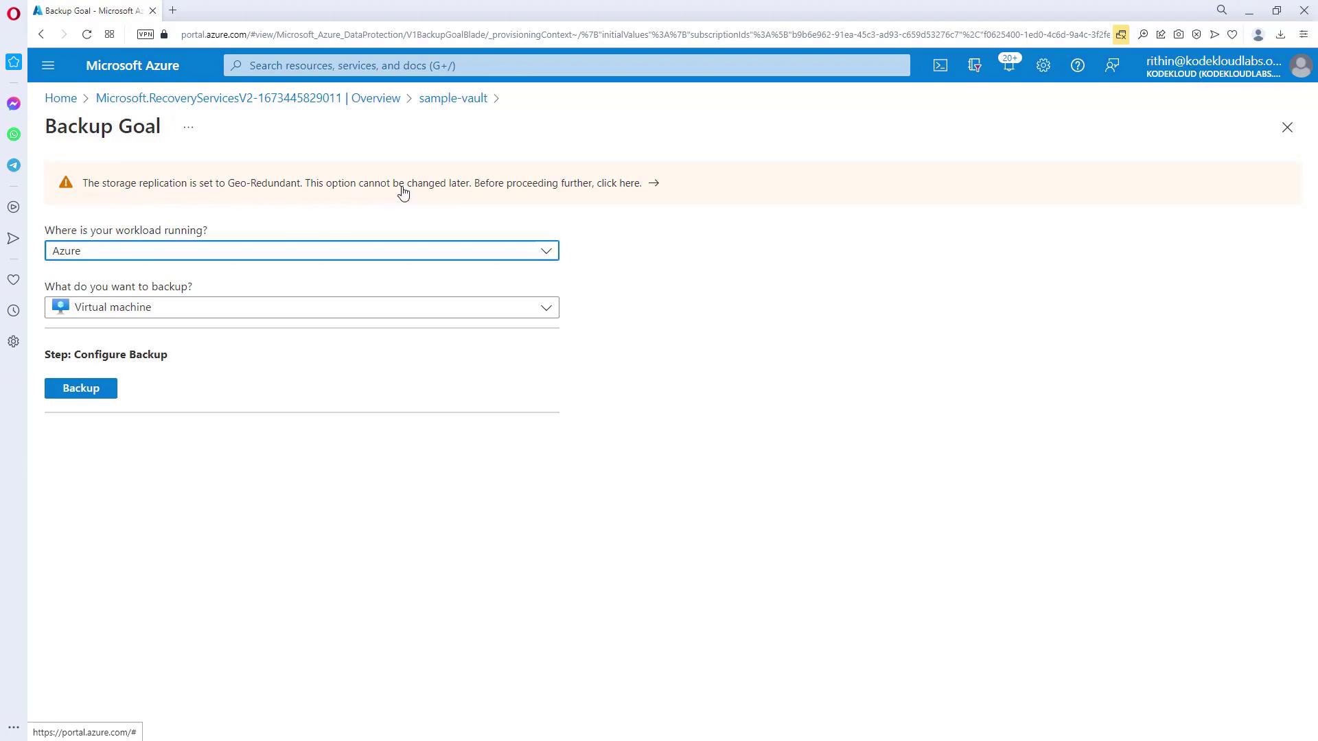The image shows a Microsoft Azure portal page for configuring a backup goal, with options to select where the workload is running and what to back up, specifically a virtual machine. A warning about storage replication being set to Geo-Redundant is also displayed.
