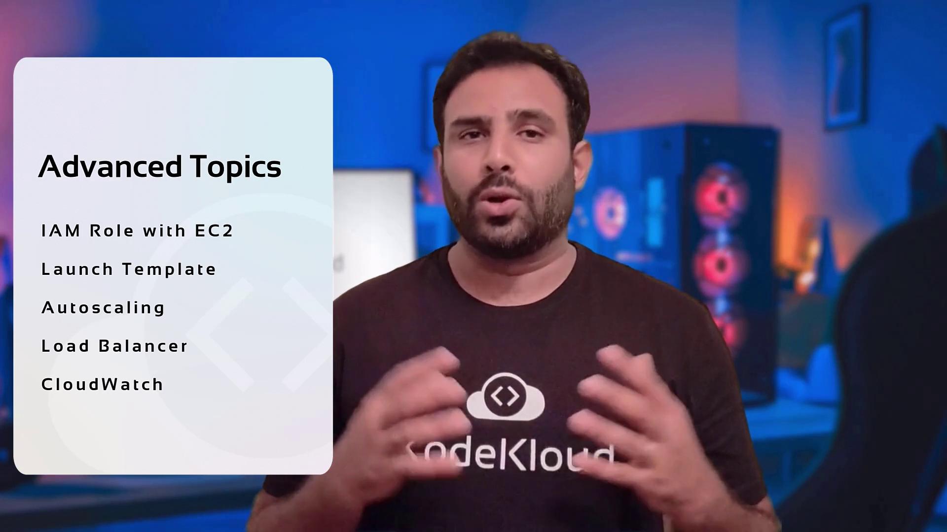 The image shows a person speaking in front of a list of advanced topics related to cloud computing, including IAM Role with EC2, Launch Template, Autoscaling, Load Balancer, and CloudWatch. The person is wearing a shirt with the "CodeKloud" logo.