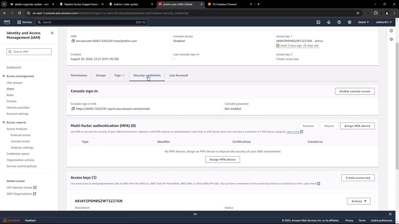The image shows an AWS Identity and Access Management (IAM) console, specifically the security credentials section for a user, displaying details like console sign-in, multi-factor authentication, and access keys.