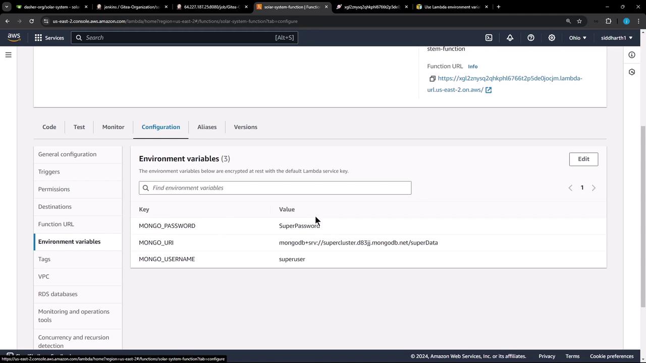 The image shows an AWS Lambda console with the "Configuration" tab open, displaying environment variables for a function, including keys and values for MongoDB connection details.