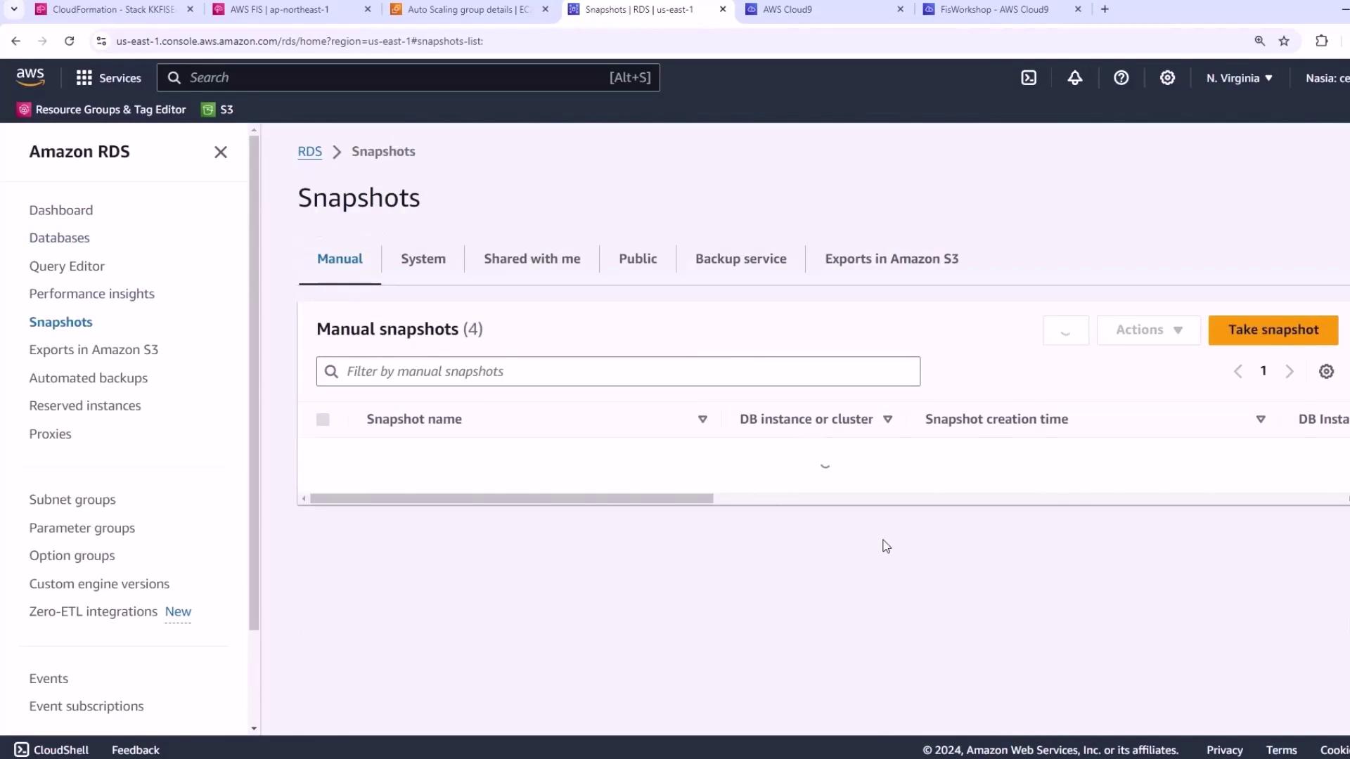 The image shows the Amazon RDS console, specifically the "Snapshots" section, where manual snapshots are listed and can be managed.