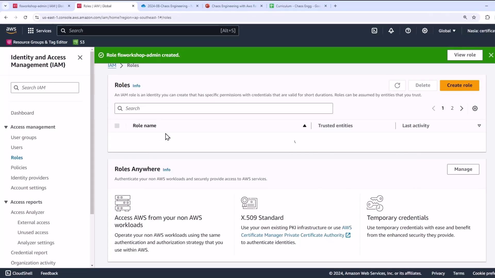 The image shows the AWS Identity and Access Management (IAM) console, specifically the "Roles" section, with a notification indicating that a role named "fisworkshop-admin" has been created.