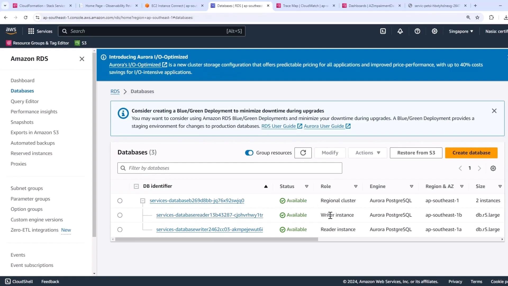 The image shows an Amazon RDS dashboard displaying a list of databases with their identifiers, status, roles, engines, and other details. It includes a banner about Aurora I/O-Optimized and a suggestion for Blue/Green Deployment.
