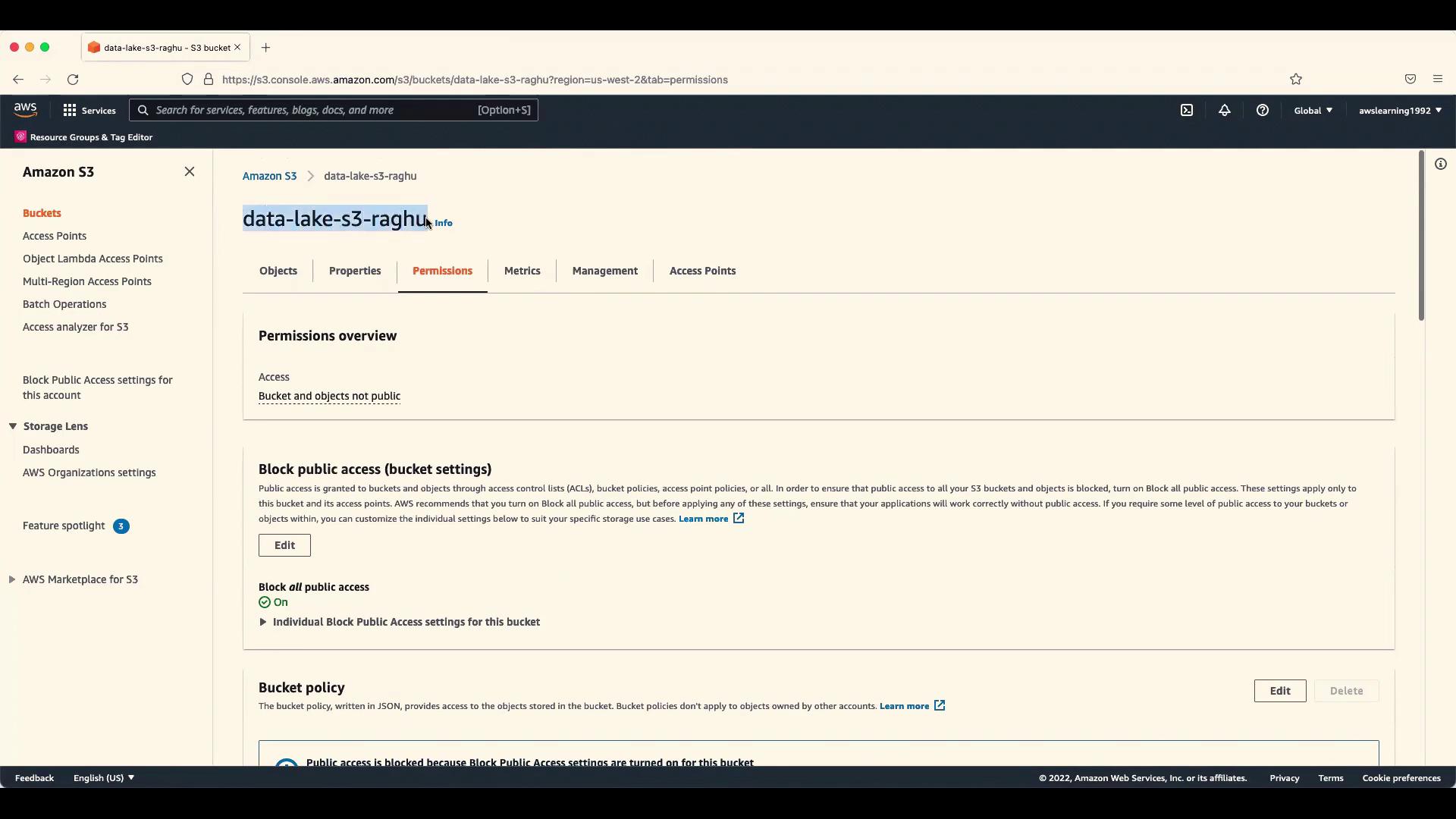 The image shows an Amazon S3 console page with the "Permissions" tab open for a bucket named "data-lake-s3-raghu." It displays settings related to blocking public access and bucket policies.