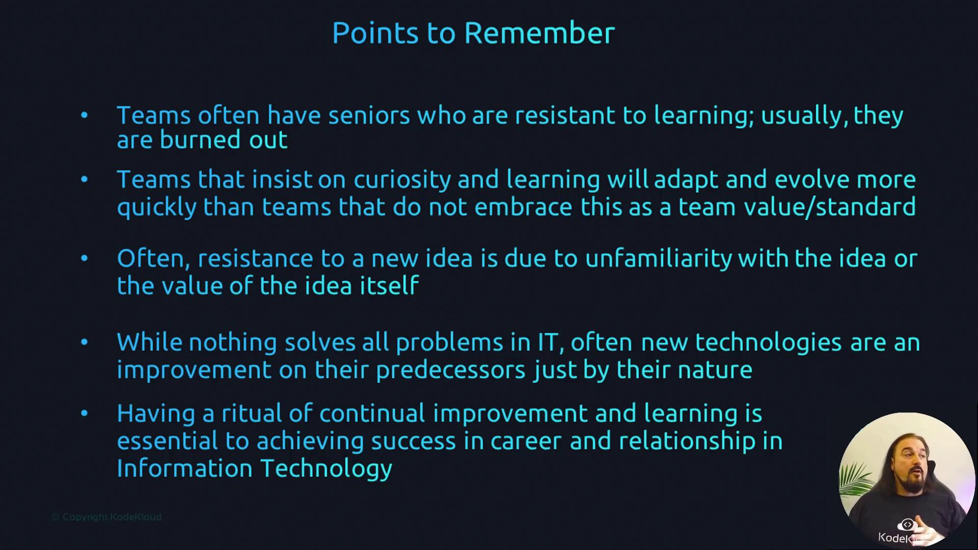 The image contains a list of points emphasizing the importance of curiosity, learning, and continual improvement in IT teams, alongside a speaker in the bottom right corner.