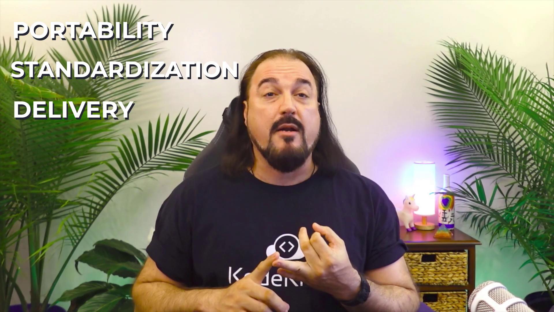 A person is speaking in front of a backdrop with plants, discussing "Portability, Standardization, Delivery," as indicated by the text on the image.