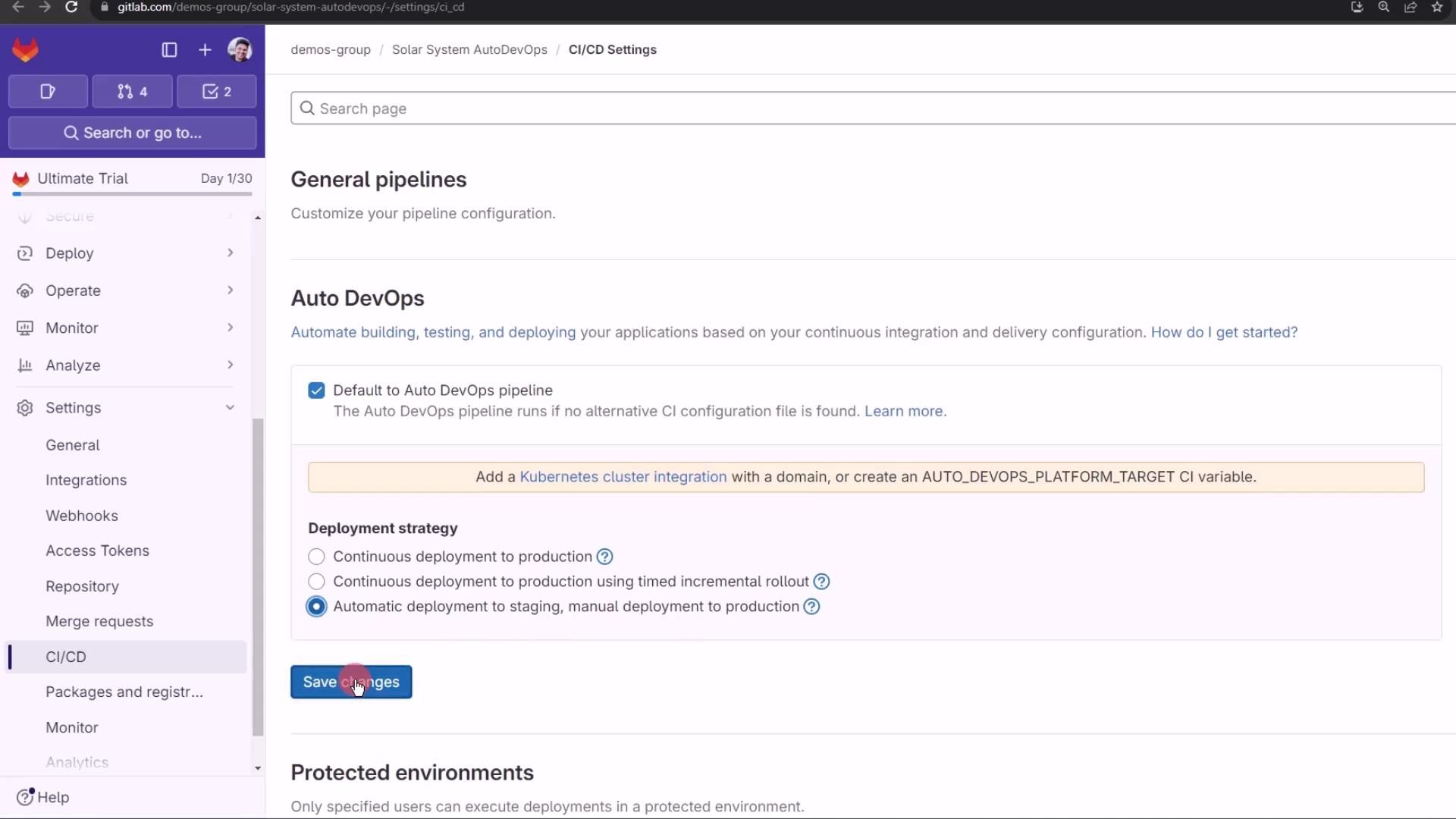 The image shows a GitLab CI/CD settings page with options for configuring Auto DevOps pipelines and deployment strategies. A user is about to click the "Save changes" button.