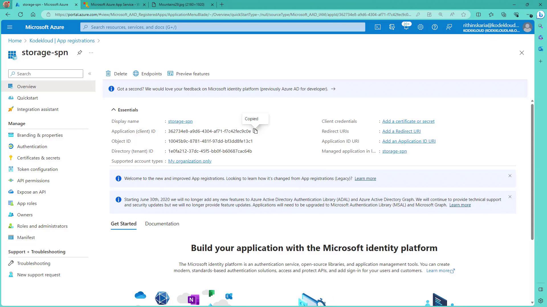 The image shows a Microsoft Azure portal page for app registrations, specifically for an application named "storage-spn." It displays details like the application ID, object ID, and directory ID, along with options for managing credentials and settings.