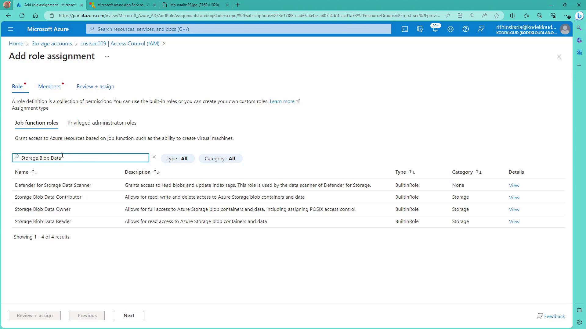 The image shows a Microsoft Azure portal page for adding a role assignment, specifically for storage blob data roles. It lists various roles like "Defender for Storage Data Scanner" and "Storage Blob Data Contributor" with their descriptions and types.
