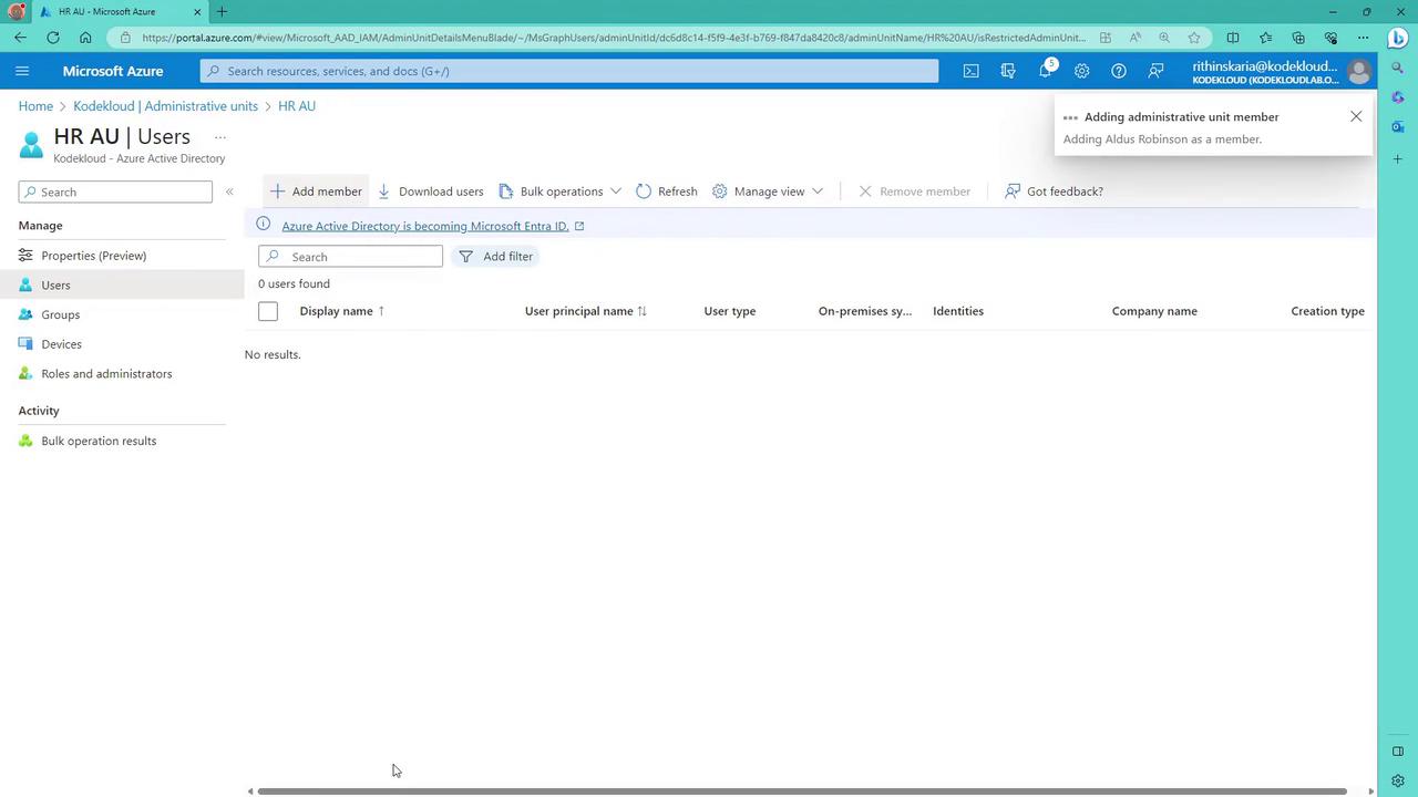 The image shows a Microsoft Azure portal interface for managing users in an administrative unit. It displays options for adding members, downloading users, and managing views, with no users currently listed.