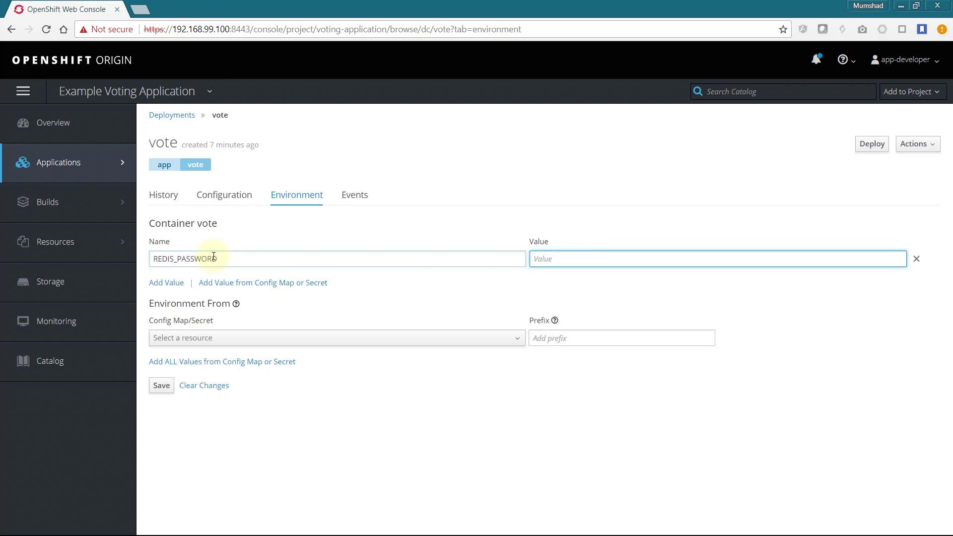 The image shows the OpenShift web console displaying the environment configuration for a container named "vote" in an example voting application. It includes fields for setting environment variables, such as "REDIS_PASSWORD."
